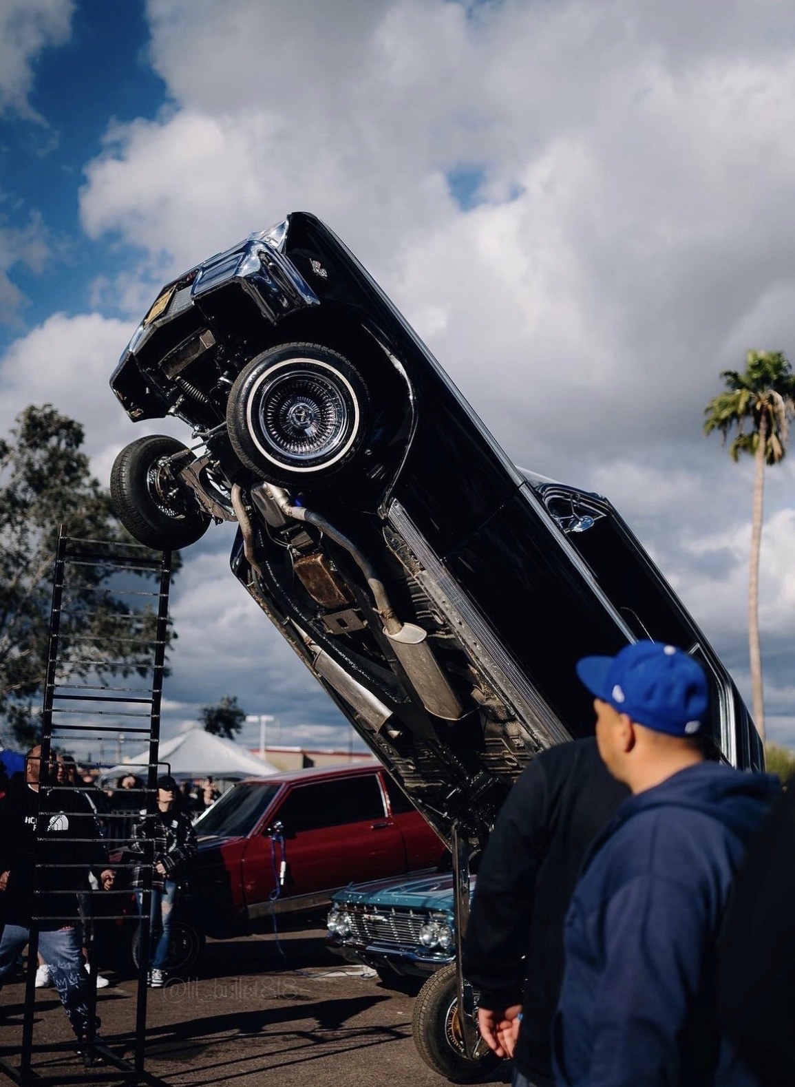Black lowrider hopper at an event