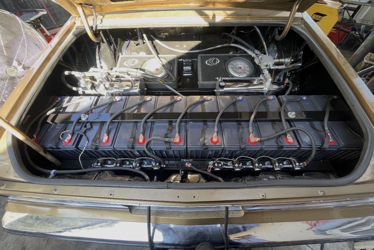 Custom hydraulic trunk setup with black batteries