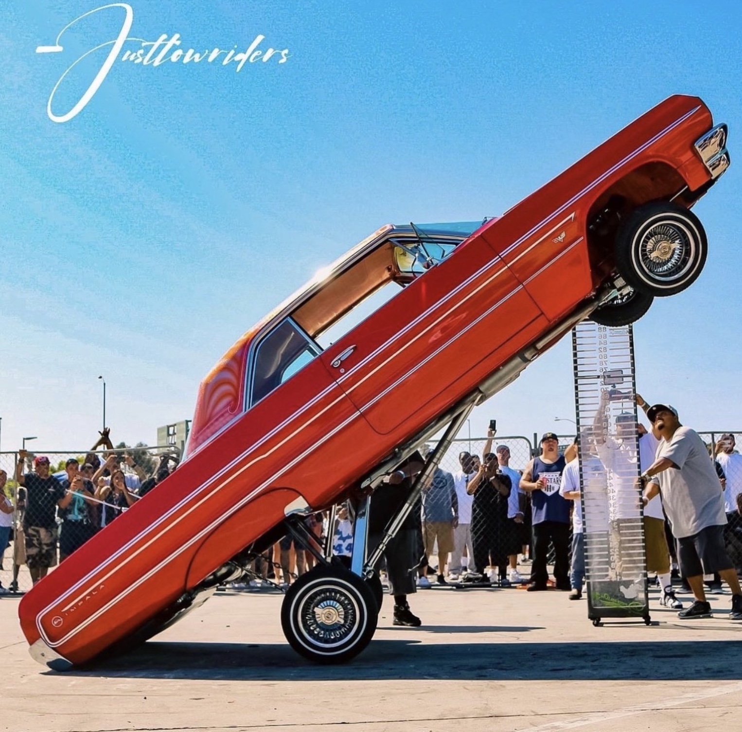 Red lowrider hopper standing tall at a show