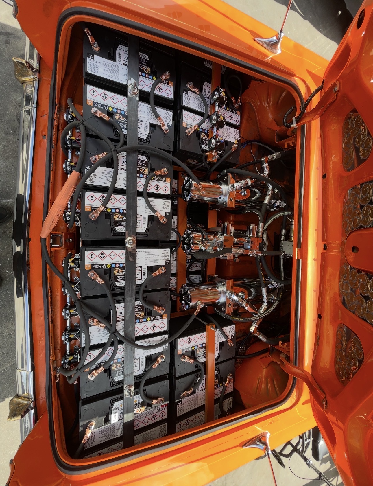Orange lowrider trunk hydraulic setup