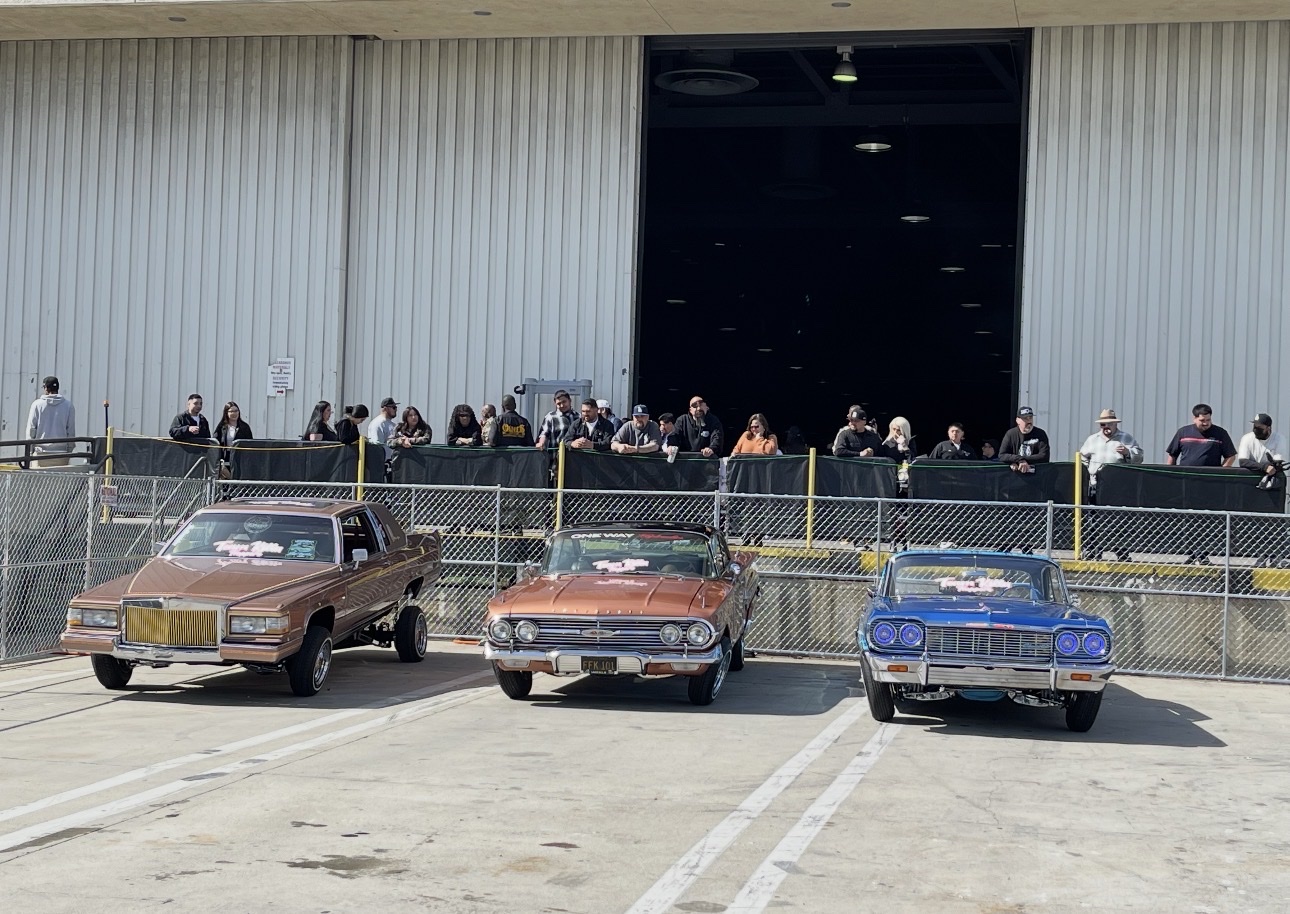 Three Team Killa lowriders lined up at an event